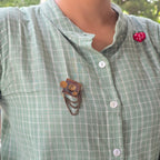 Square brooch with chain and disc embellishments