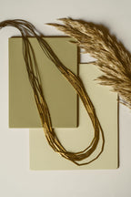 Multi-layered long brass tube necklace